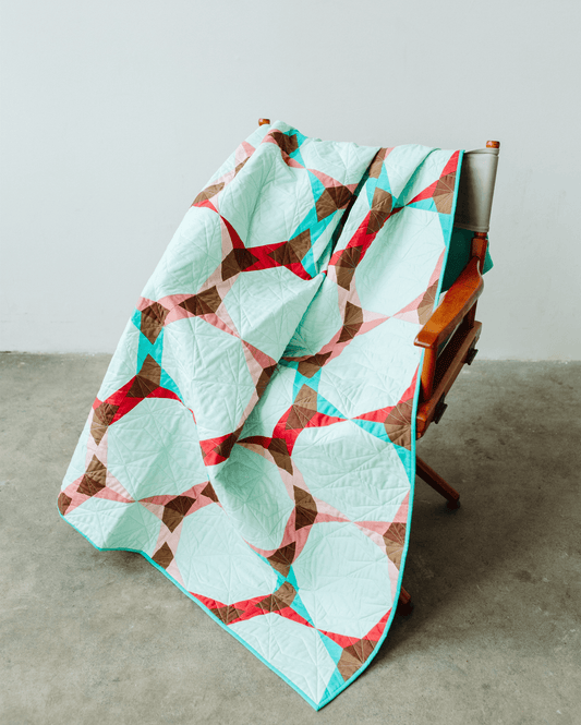 A teal Night Bloom quilt.