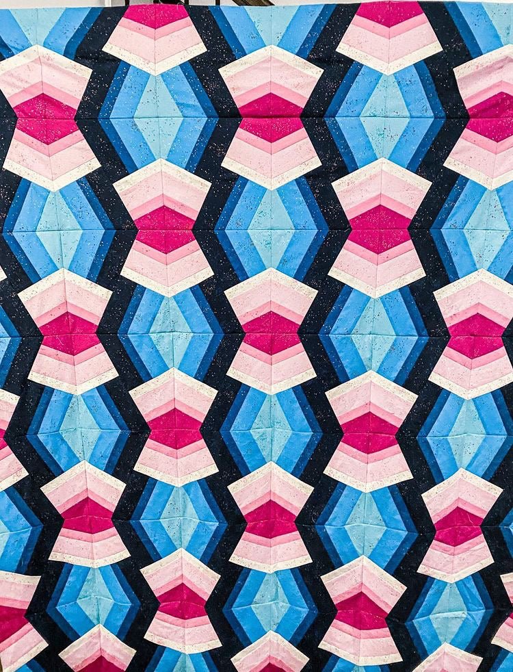 A pink and blue Bracken quilt.