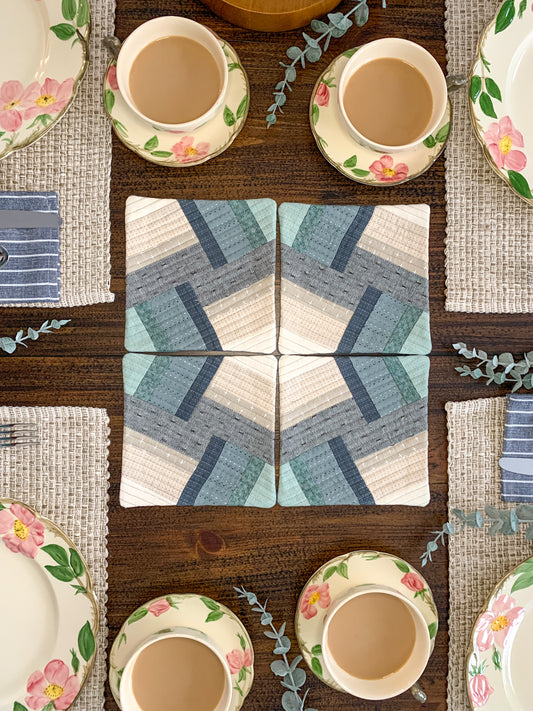 Mini Bracket Quilt Pattern - Julia Wachs Designs - A table set with mini Bracken trivets in the center.
